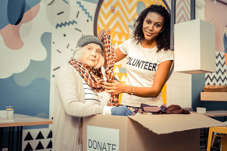 volunteer helping an od woman